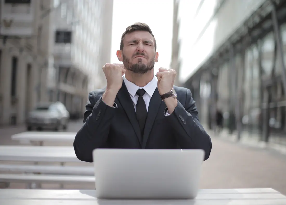 Founder celebrating the first sale at his laptop